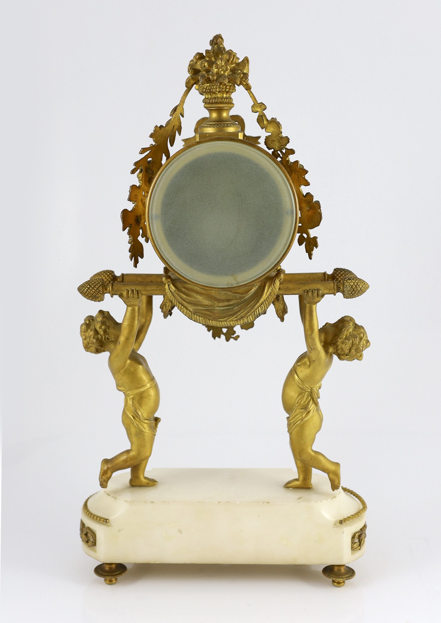 A French Louis XVI style ormolu and white marble mantel clock, 26cm wide, 48cm high